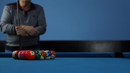 A pool table. Parts of a pool table close-up. American pool table. Billiard balls. Billiard balls in the table with blue surfaces. Billiard player wiats to play