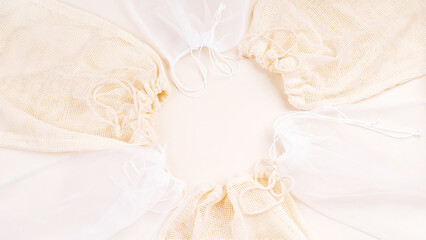 Fototapeta premium A variety of eco bags on a white background.Sustainable lifestyle.Eco Bags.Zero waste minimal composition with tring and canvas bags for storage.Zero waste, eco friendly shopping. Top view, flat lay.