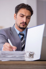 Young male employee working in the office