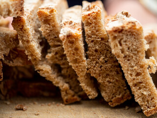 Close up of homemade bread slices. It is so fresh that the room is filled with the scent of freshly baked bread. 
