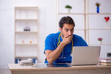 Young male doctor in telemedicine concept
