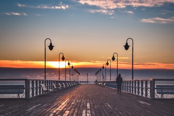 Beautiful morning seaside landscape. Wooden pier with a colorful sky in Gdynia Orlowo, Poland.
