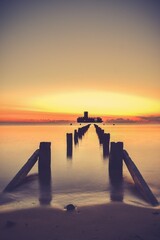 Beautiful sunrise over the Polish sea. The building of the old torpedo house in the Baltic Sea in...