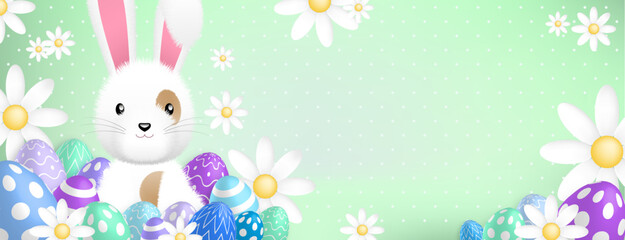 a cute white rabbit behind colored eggs and flowers on a green background