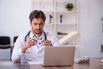 Young male doctor working in the clinic