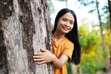 Asian women huging trees , the concept of love for the world