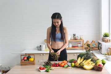 young Asian woman person cooking in kitchen with a healthy food concept, drink and organic vegetable