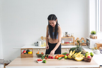 young Asian woman person cooking in kitchen with a healthy food concept, drink and organic vegetable