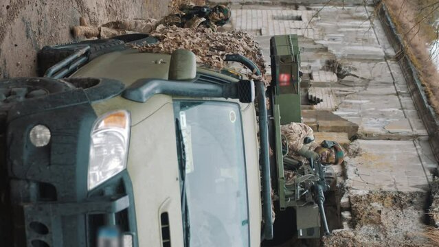 Vertical Video - Army marine squad taking over civilian territory with grit debris. High quality 4k footage