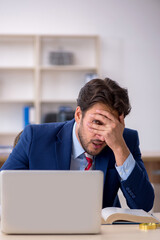 Young male employee working in the office