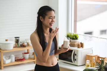 young Asian woman person cooking in kitchen with a healthy food concept, drink and organic vegetable