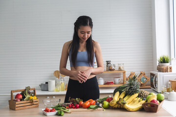 young Asian woman person cooking in kitchen with a healthy food concept, drink and organic vegetable