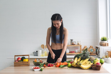 young Asian woman person cooking in kitchen with a healthy food concept, drink and organic vegetable