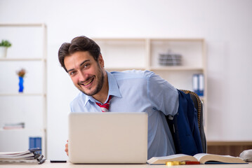 Young male employee working in the office