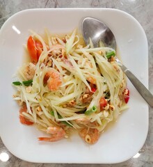papaya salad on white plate,