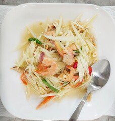 papaya salad on white plate,