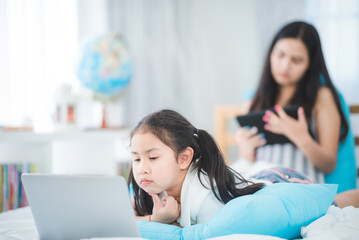 mother teaching child girl for doing homework at home, family education activity concept