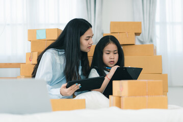 mother teaching child girl for doing homework at home, family education activity concept