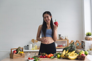 young Asian woman person cooking in kitchen with a healthy food concept, drink and organic vegetable