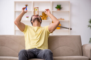 Fototapeta na wymiar Young man staying at home during pandemic