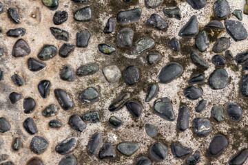 The arrangement of gravel mixed with cement used for pavement corridors in the garden, creates the impression of returning to nature, for a background with a nature theme