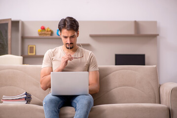 Young male employee working from house