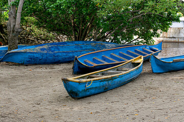 Typical blue boats from Coveñas, Sucre, wait on the beach.