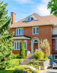 luxury house with garage door, big tree and nice spring blossom