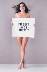 Your body hears everything your mind says so stay positive. Studio portrait of an attractive young woman holding a sign that reads Im sexy and I know it against a pink background. © Tamani Chithambo/peopleimages.com