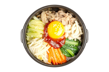 Homemade Korean Mixed Rice called Bibimbap, includes steamed rice, vegetables, pork and fresh egg yolk on top, served in a hot stone pot, isolated on white background. Clipping path