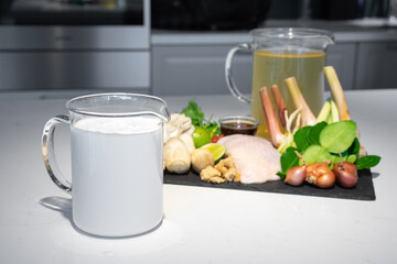 Focus on coconut cream milk, one of ingredients set for Thai food, Coconut milk with chicken soup menu. The ingredients are chicken vegetable and many types of herbs together combine as a great dish.