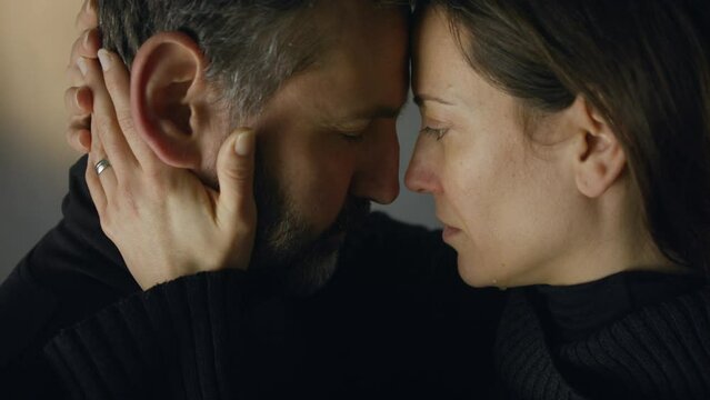 Close-up of woman crying when hugging her husband.