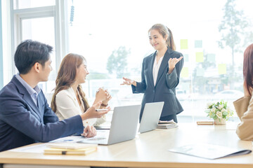 Entrepreneurs and business people conference in modern meeting room, happy multiracial coworkers have fun cooperating working together at office meeting, asian teamwork concept