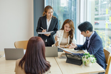 Entrepreneurs and business people conference in modern meeting room, happy multiracial coworkers have fun cooperating working together at office meeting, asian teamwork concept