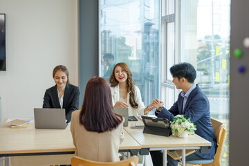 Entrepreneurs and business people conference in modern meeting room, happy multiracial coworkers have fun cooperating working together at office meeting, asian teamwork concept