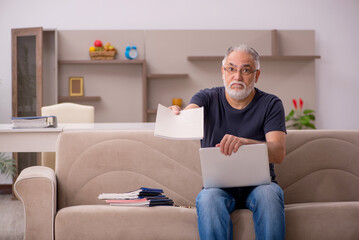 Old male employee working from home during pandemic