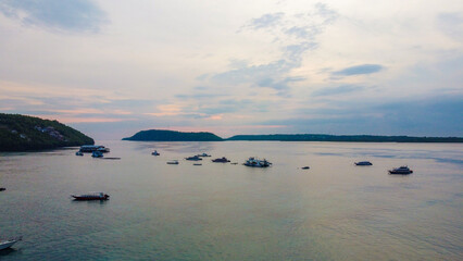 Aerial drone bird's eye view from the pier with clear waters at dusk