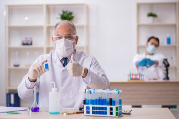 Two male chemist working at the lab