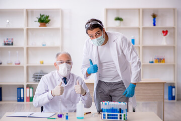 Two male chemist working at the lab