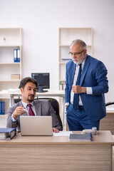 Two male colleagues working in the office