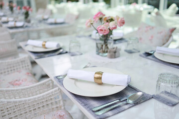 The wedding decor. Tables set for an event party or wedding reception. luxury elegant table setting dinner in a restaurant. glasses and dishes. hall for banquets and weddings.