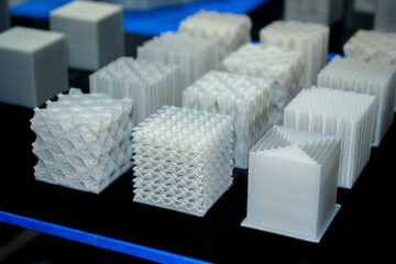 Objects printed on 3d printer made of white plastic close-up. Models created on 3D printer from...