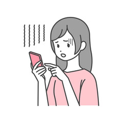 不安そうにスマートフォンを操作する女性