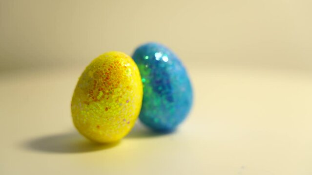 Colorful Easter eggs rotating in rows in a seamless loop on a light background