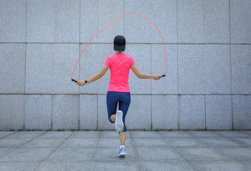 Fitness asian woman jumping rope