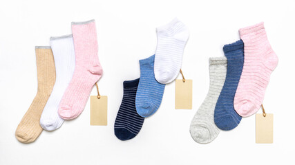 Various modern trendy women's cotton socks set with price tags on white background. Fashionable socks store. Socks shopping, sale, merchandise, advertisement concept. Flat lay, top view
