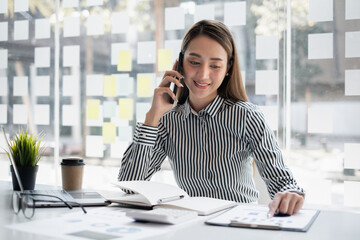 Business woman discuss with partners talking by cell phone. Female technical support agent trying...