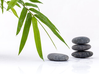 Fototapeta na wymiar The stacked of Stones spa treatment scene and bamboo leaves with raindrop zen like concepts.