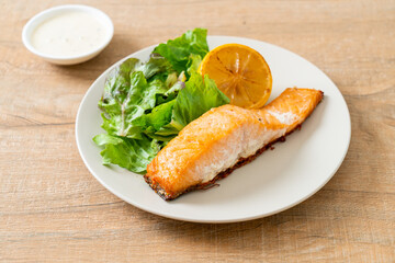 fried salmon steak with lemon and vegetable