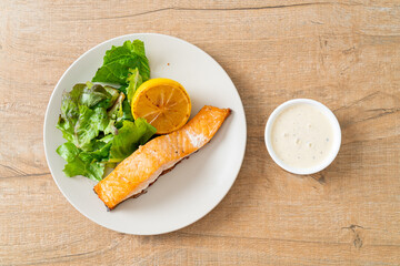 fried salmon steak with lemon and vegetable